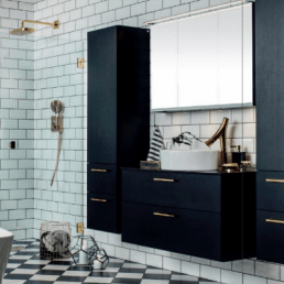 sort baderominnredning med messing detaljer